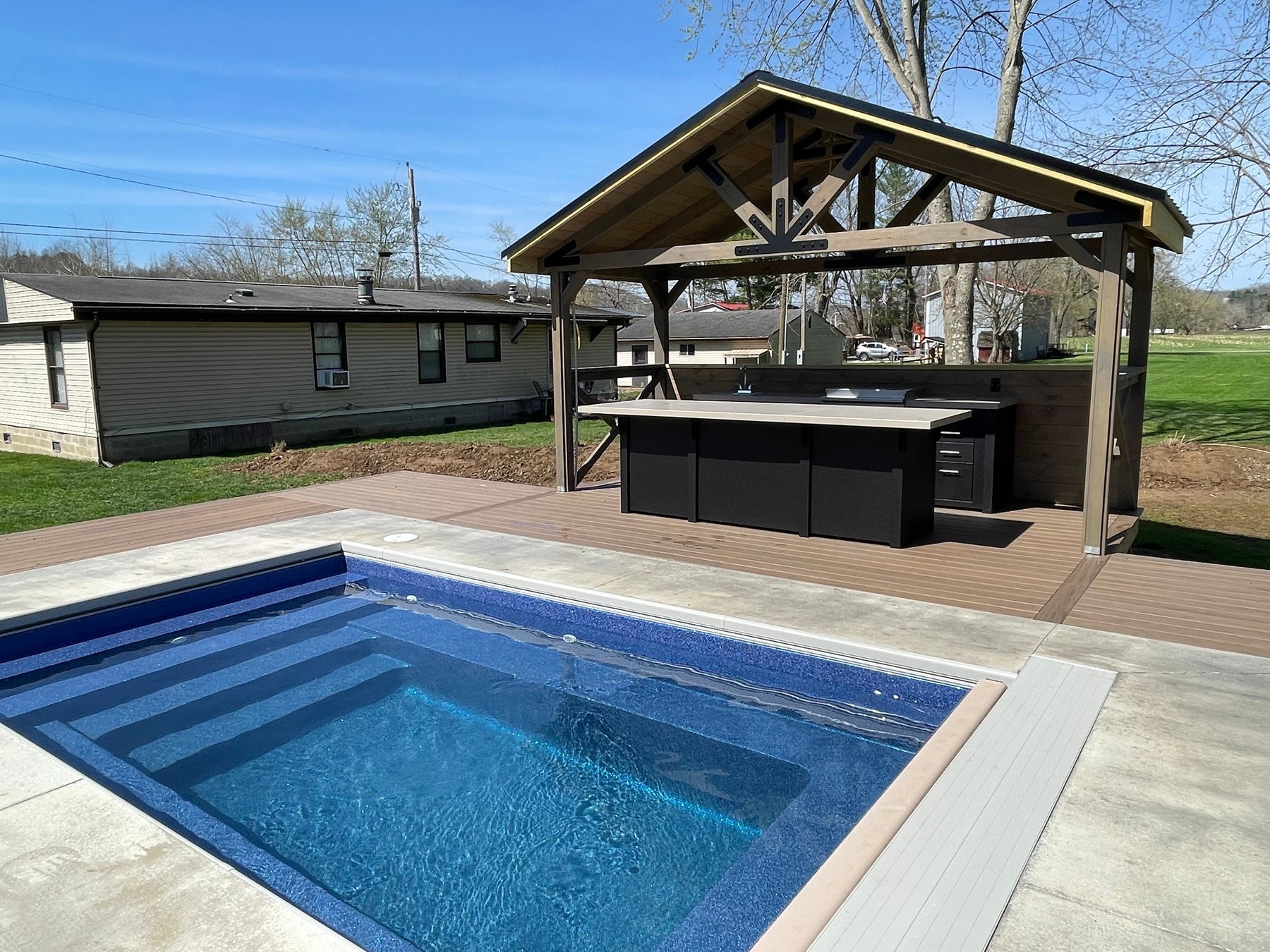 Stono Outdoor Living Engineered Outdoor Kitchen in backyard setting near pool