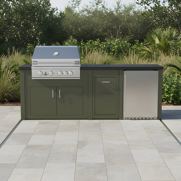 The Sullivan, a Stono engineered outdoor kitchen island with a green finish, a built-in grill and refrigerator, installed on a tiled patio surrounded by trees.