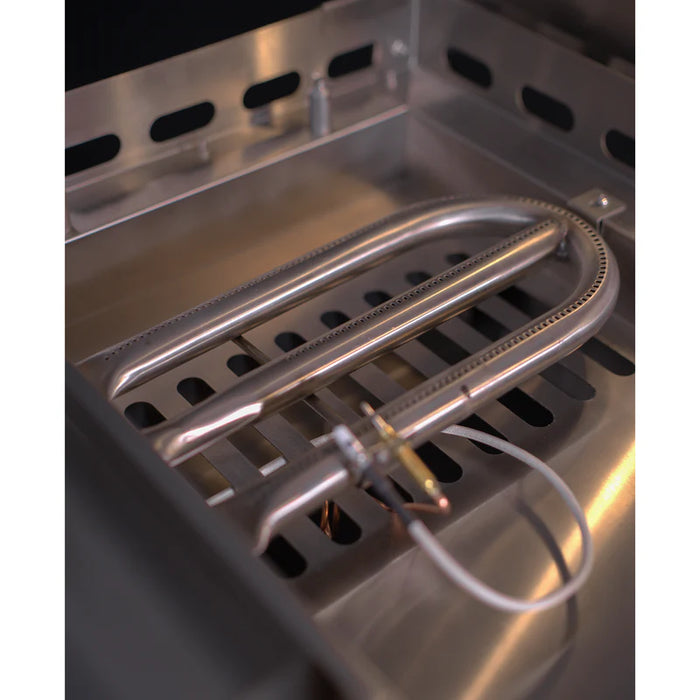 Stono Outdoor Living Close-up of a Le Griddle Pro Series 105 (OML105P3) U-shaped 304 stainless steel burner inside the 3-burner natural gas griddle, highlighting clean surfaces, burner ports, ignition wire, and interior lights.