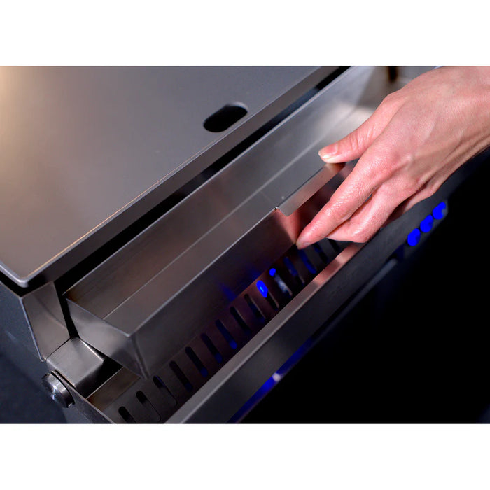 Stono Outdoor Living A hand opens the stainless steel lid of the Le Griddle Pro Series 40 (OML40P3), revealing a compartment with interior lights underneath.